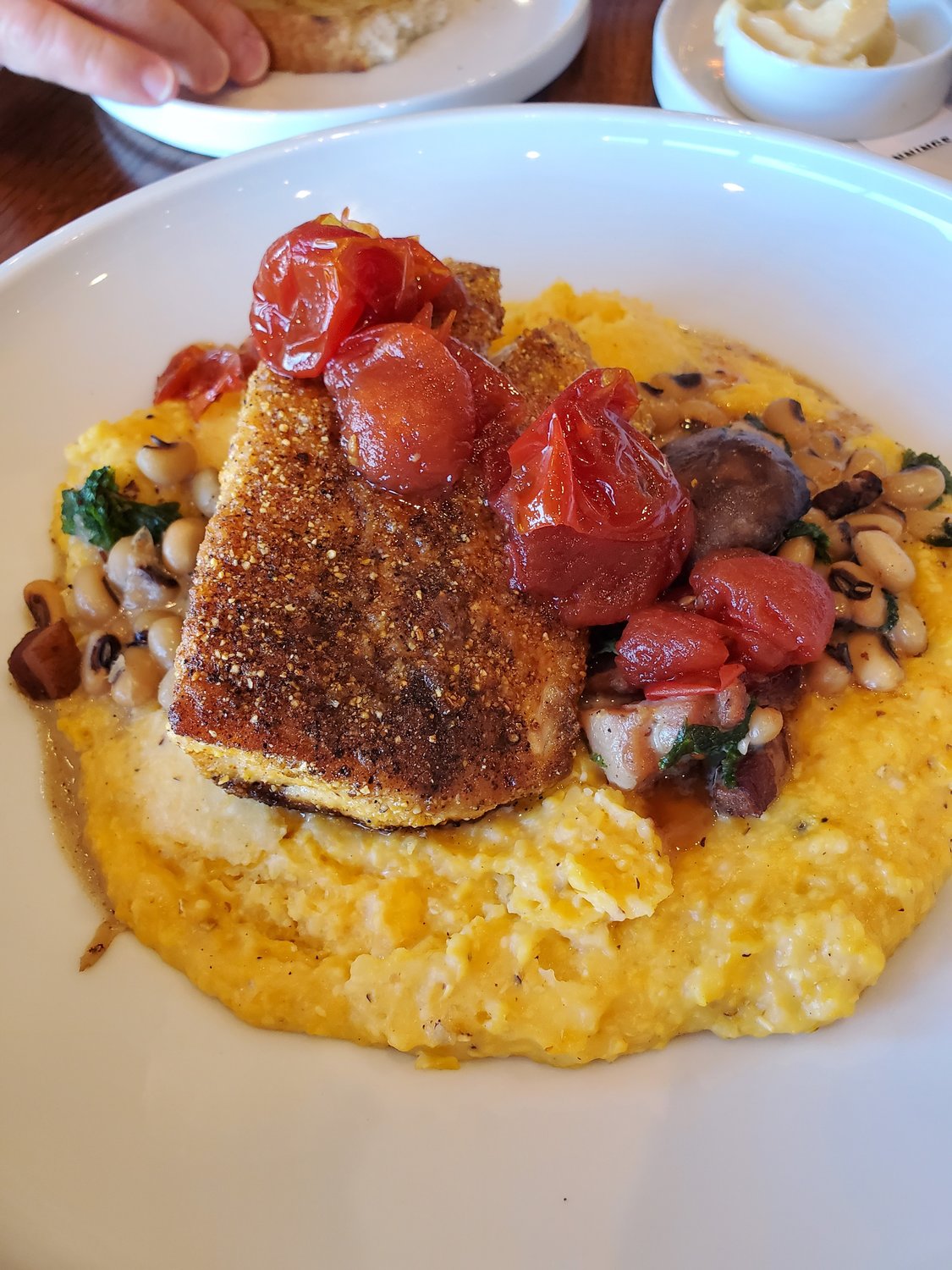 Fish fans will love the cornmeal-fried red fish surrounded by Logan Turnpike Mill Grits, creamy field peas with brown butter mushrooms and tomato jam.